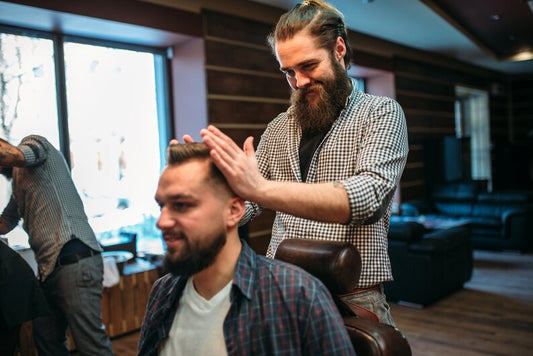 Barbers and stylists working on clients