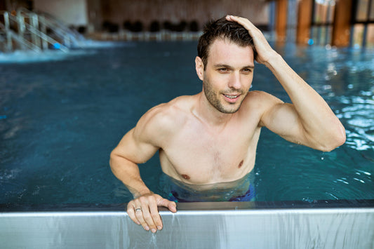 Man preparing hair before swimming with conditioner