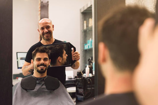 Client admiring finished hair and beard combo in mirror