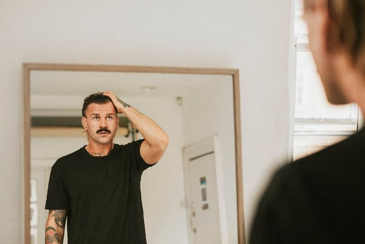Man using hair product at home