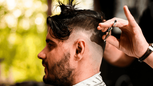 Close-up side profile of a man showing off a perfectly blended high zero fade haircut with defined edges.