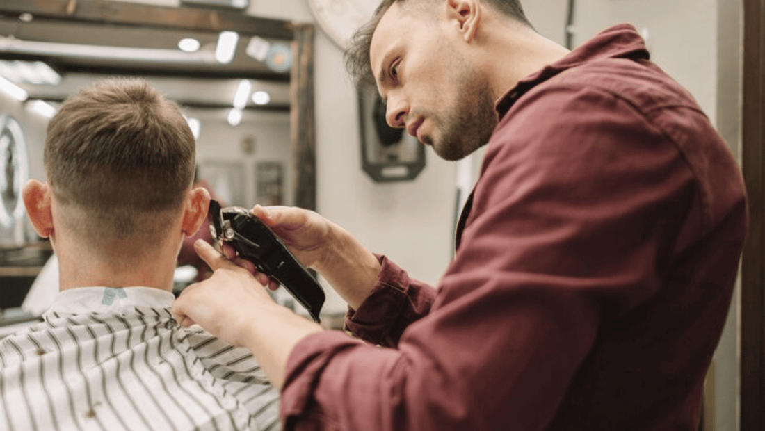 Barber styling a client at Allan’s Men’s Hairdressing in Brisbane